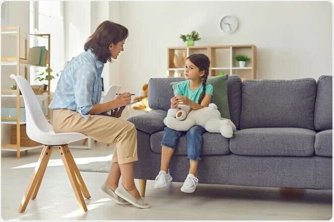 Assessments Woman Leaning Forward on Chair Assessing A Child Holding A Teddy Bear Secure Minds Psychology